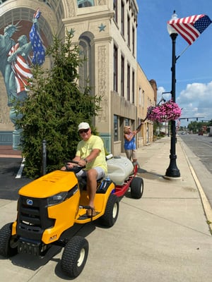 Harold and Marylyn Strang watering hanging baskets in downtown Bucyrus 2020