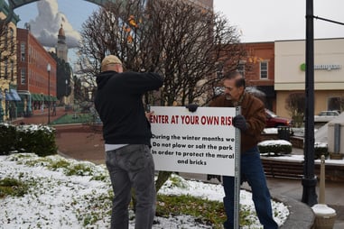 Installing winter signs at Millennial Park